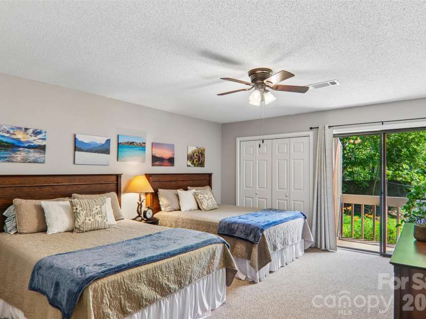 147 Lake Drive, Lake Lure, NC 28746.  MLS# CAR4385694, YatesRealty ID 29092. Second large bedroom with private deck overlooking lake