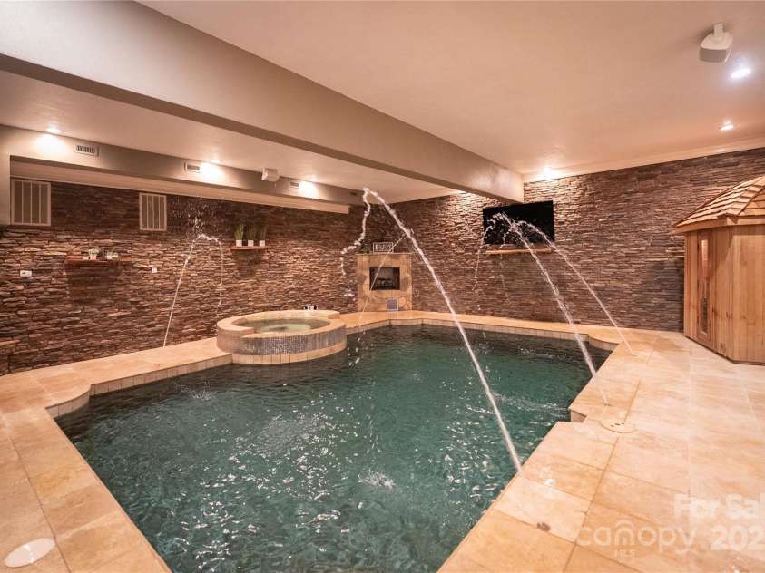 305 Mallard Drive, New London, NC 28127.  MLS# CAR4278141, YatesRealty ID 29094. A true oasis on the water front. Indoor Home SpaSauna, Hot Tub, Heated Pool, Gas Log fireplace