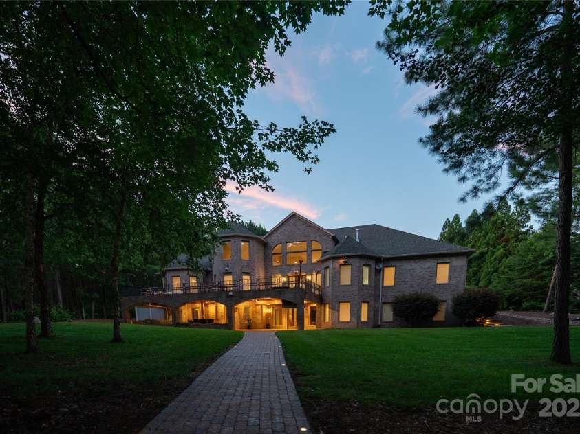 305 Mallard Drive, New London, NC 28127.  MLS# CAR4278141, YatesRealty ID 29094. Rear of the home. Gorgeus Deck with Tigerwood flooring, gas hookups and a firetable. Plus an outdoor Patio with bar, fans, tv, lighting.