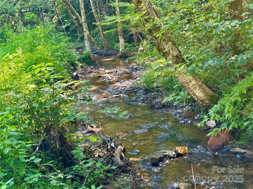 492 Chestnut Mountain Road, Spruce Pine, NC 28777.  MLS# CAR4281456, YatesRealty ID 29100. Creek across street