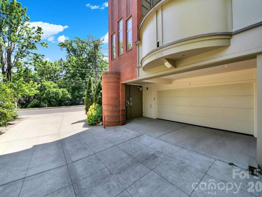 1930 Scott Avenue, Charlotte, NC 28203.  MLS# CAR4367127, YatesRealty ID 29105. Attached two-car garage featuring premium poly-coat floors and a convenient separate walk-through entry door.