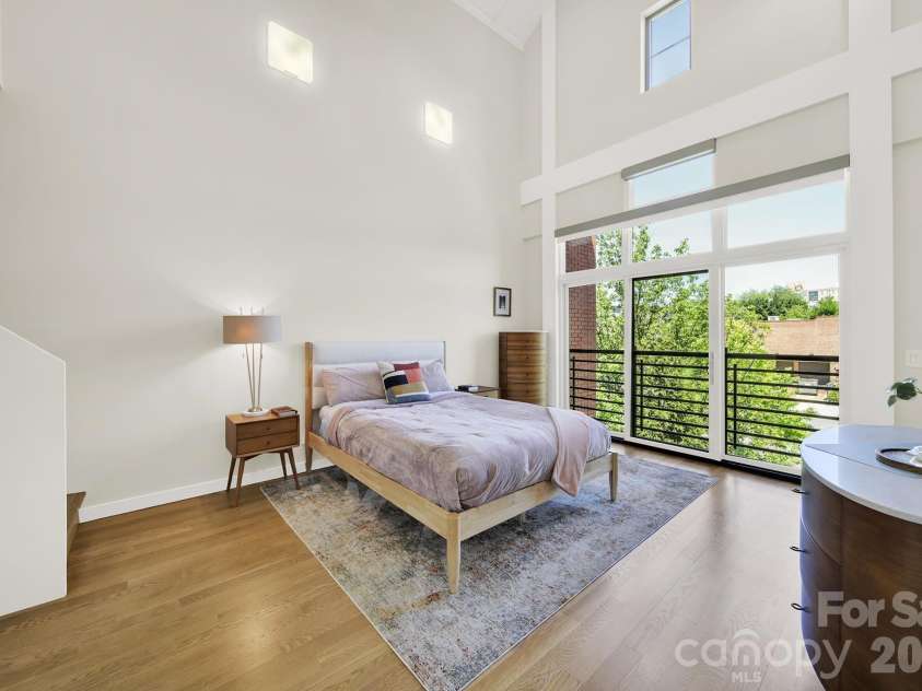 1930 Scott Avenue, Charlotte, NC 28203.  MLS# CAR4367127, YatesRealty ID 29105. Light-filled primary suite with a dramatic 19-ft barrel-vaulted ceiling.