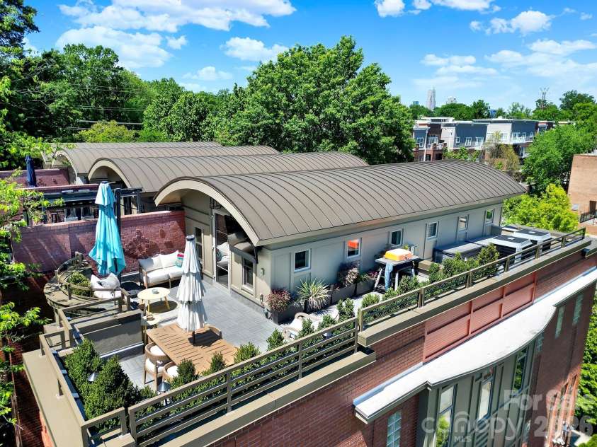 1930 Scott Avenue, Charlotte, NC 28203.  MLS# CAR4367127, YatesRealty ID 29105. Rear exterior view showcasing the solid brick construction and multi-level private balconies (not a shared space).