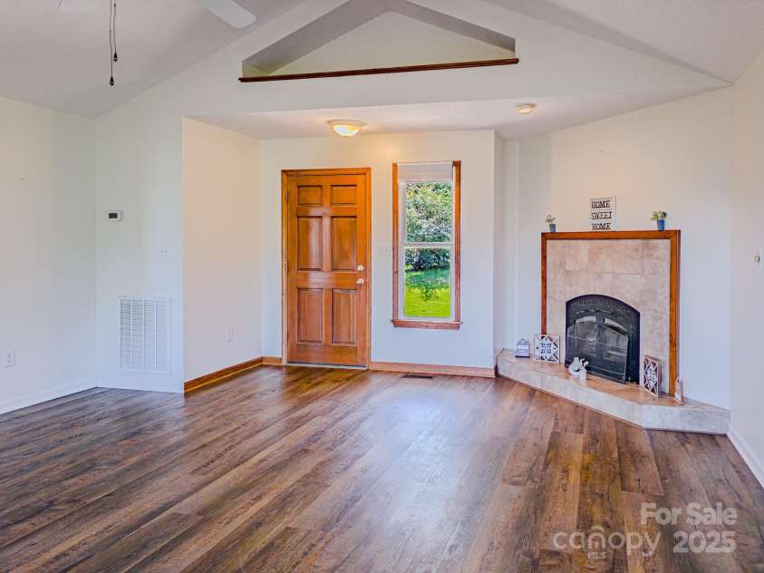 485 Mountain Lookout Drive, Bostic, NC 28018.  MLS# CAR4286310, YatesRealty ID 29110. Living room with wood burning fireplace
