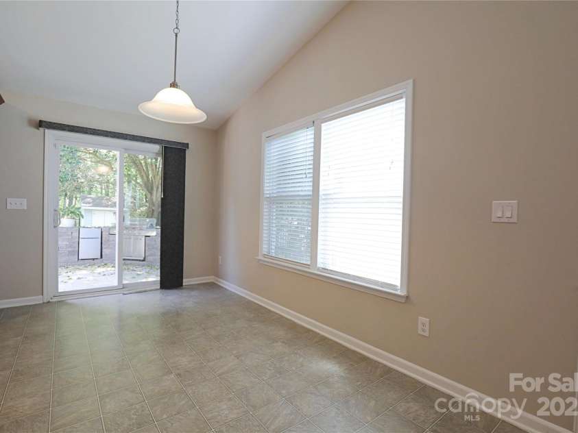 9814 Fernspray Road, Charlotte, NC 28215.  MLS# CAR4254340, YatesRealty ID 29114. Dining area is large and connects kitchen and living room to outdoor living space