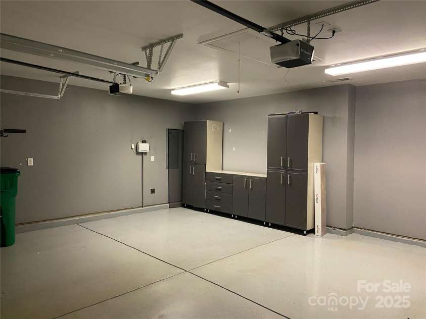 9814 Fernspray Road, Charlotte, NC 28215.  MLS# CAR4254340, YatesRealty ID 29114. Garage with epoxy floor and storage cabinets that convey