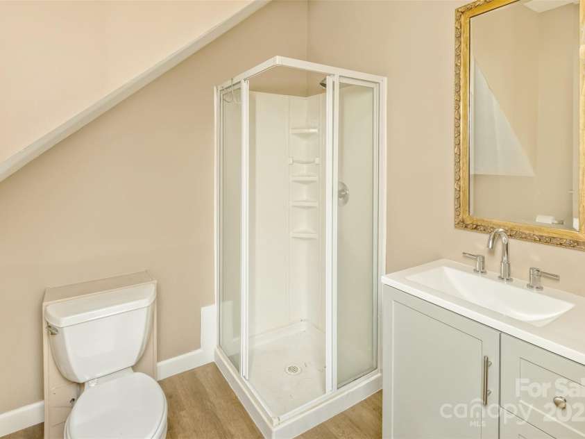 15 Beaverdam Knoll Road, Asheville, NC 28804.  MLS# CAR4283730, YatesRealty ID 29131. The apartment bathroom features a new vanity and updated flooring.