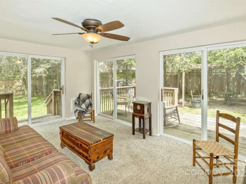 15 Beaverdam Knoll Road, Asheville, NC 28804.  MLS# CAR4283730, YatesRealty ID 29131. The light-filled sunroom could also serve as an additional main level guest bedroom. Roughed-in plumbing is hidden under a trap door in the carpeted area to allow for easy plumbing access for future expansion ideas