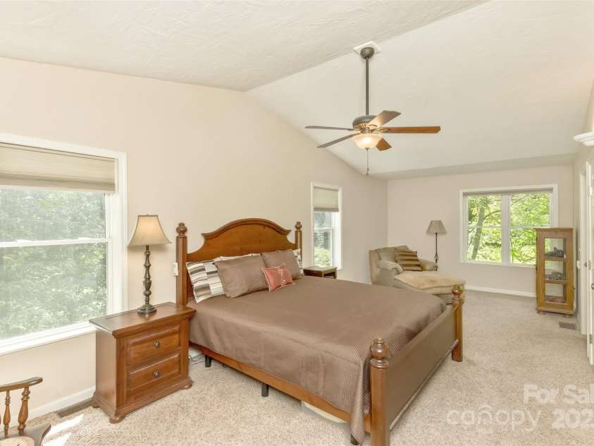 15 Beaverdam Knoll Road, Asheville, NC 28804.  MLS# CAR4283730, YatesRealty ID 29131. The main primary bedroom suite is large and has several desirable features: multiple closets, built-in storage, a private office/nursery, a screened balcony porch and easy access to the main covered deck area.