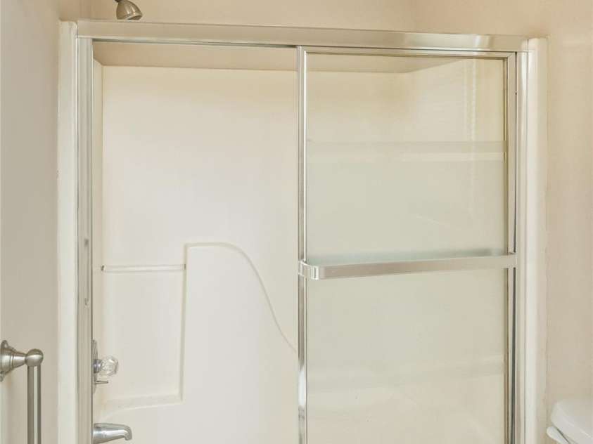 15 Beaverdam Knoll Road, Asheville, NC 28804.  MLS# CAR4283730, YatesRealty ID 29131. The toilet room with a glass-enclosed shower/tub has a separate door for additional privacy.