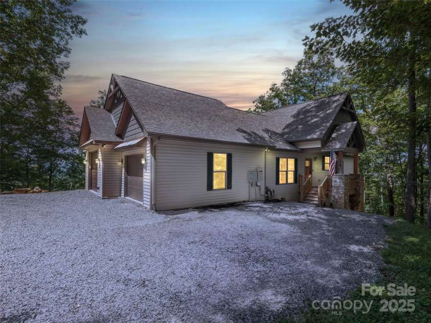 1070 Gold City Lane, Franklin, NC 28734.  MLS# CAR4282550, YatesRealty ID 29132. As the sun dips below the ridgeline, this mountaintop home comes to life.
