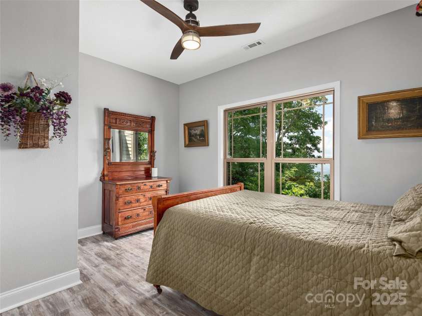 1070 Gold City Lane, Franklin, NC 28734.  MLS# CAR4282550, YatesRealty ID 29132. Charming second bedroom with peaceful mountain views and cozy vintage touches.
