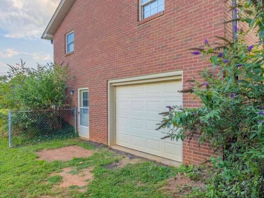 101 Hillsdale Lane, Taylorsville, NC 28681.  MLS# CAR4277637, YatesRealty ID 29135. Side of home with garage door and baseline entry door