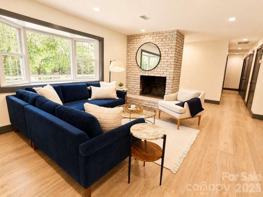 35 Timberview Drive, Arden, NC 28704.  MLS# CAR4373385, YatesRealty ID 29135. Spacious great room with a striking whitewashed brick fireplace
