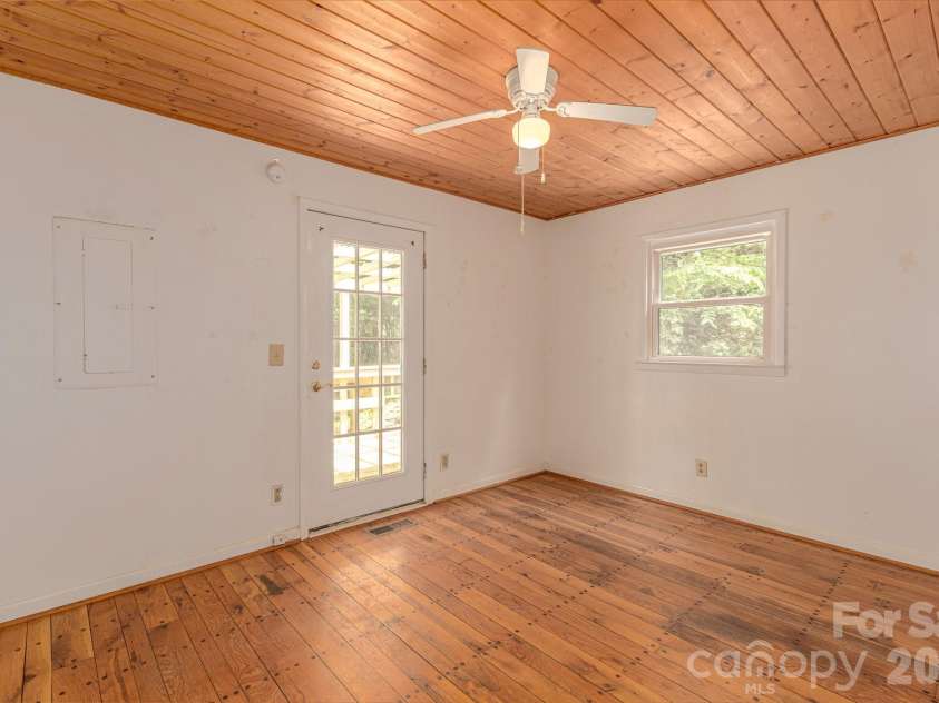 295 Richmond Road, Bakersville, NC 28705.  MLS# CAR4387768, YatesRealty ID 29139. Bedroom with door to side deck that wraps around to the back.