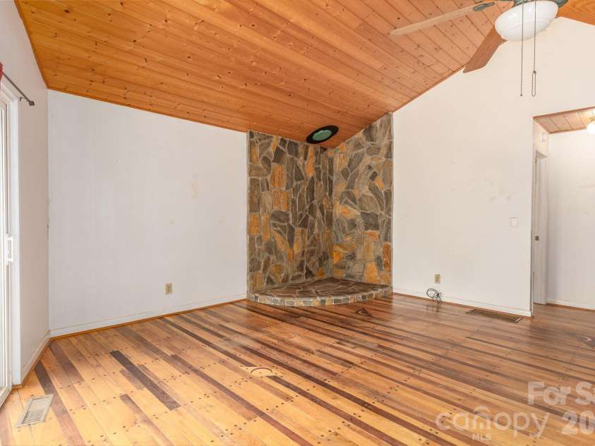 295 Richmond Road, Bakersville, NC 28705.  MLS# CAR4387768, YatesRealty ID 29139. Stone hearth, previously had a woodstove.
