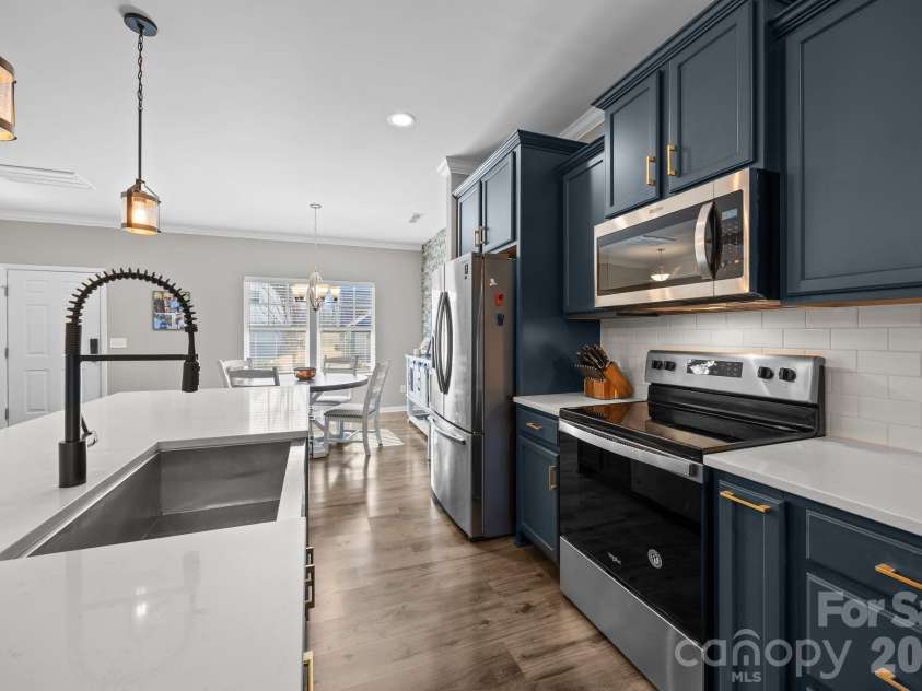 204 Old Harbor Drive, Mount Gilead, NC 27306.  MLS# CAR4335591, YatesRealty ID 2914. Kitchen with large island, owner upgraded the pendant lights recently.