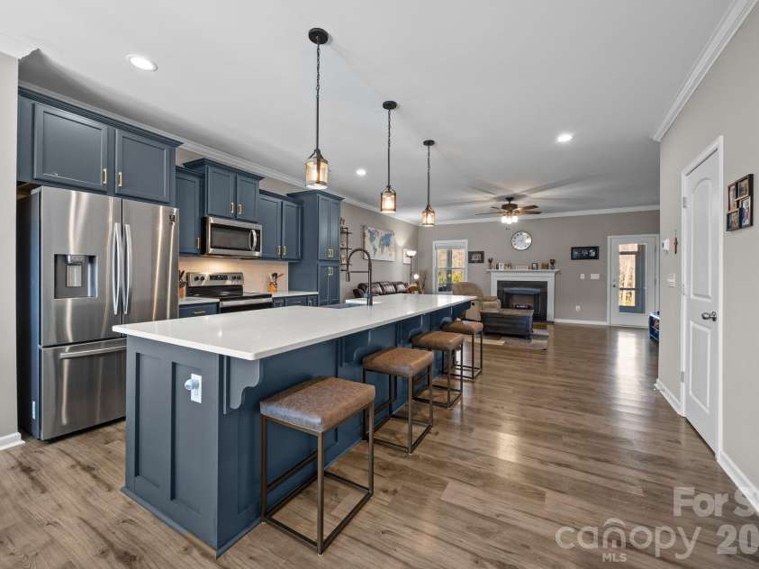 204 Old Harbor Drive, Mount Gilead, NC 27306.  MLS# CAR4335591, YatesRealty ID 2914. Large Island for casual dining/breakfast. Owner updated the pendant lighting.