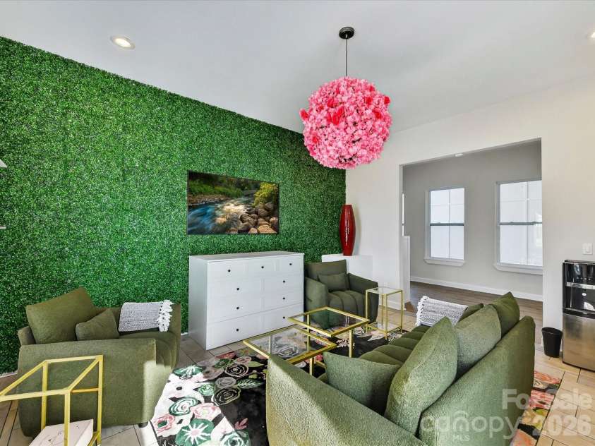 4987 Wildlife Lane, Sherrills Ford, NC 28673.  MLS# CAR4353607, YatesRealty ID 29143. Stylish flex space featuring cozy seating space, a statement accent wall, and modern decor perfect for lounging or entertaining.