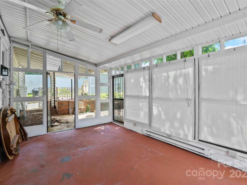 23 & 25 Oteen Park Place, Asheville, NC 28805.  MLS# CAR4287838, YatesRealty ID 29157. Relax on the back patio that features privacy blinds, large windows with screens, and a ceiling fan so you can enjoy being outside without bugs or pollen!