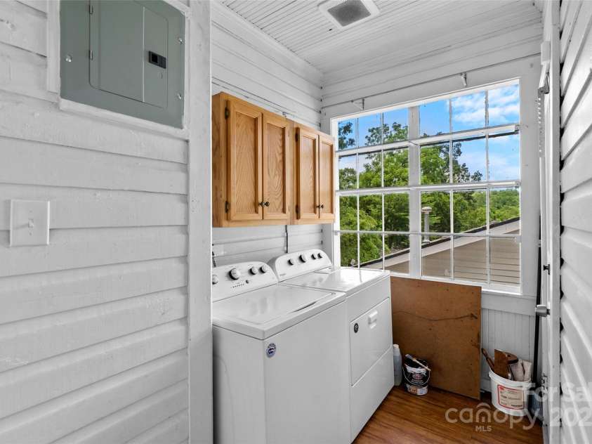 23 & 25 Oteen Park Place, Asheville, NC 28805.  MLS# CAR4287838, YatesRealty ID 29157. The happy Laundry room is located conveniently on the main level just off the kitchen. It can also be accessed from another entrance off the driveway.
