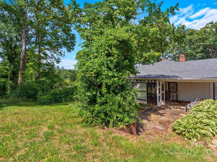 23 & 25 Oteen Park Place, Asheville, NC 28805.  MLS# CAR4287838, YatesRealty ID 29157. The low-maintenance back yard features a patio area, enough space for a garden, and room for a pet to get some exercise.