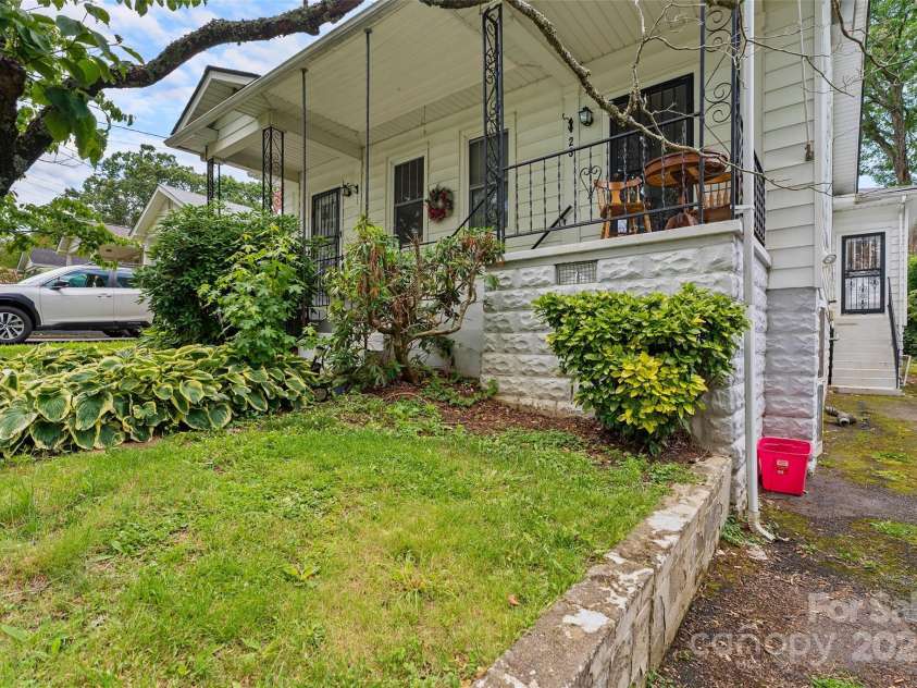 23 & 25 Oteen Park Place, Asheville, NC 28805.  MLS# CAR4287838, YatesRealty ID 29157. The paved driveway with off street parking for two cars is located to the right of the home, the same side as unit 23.