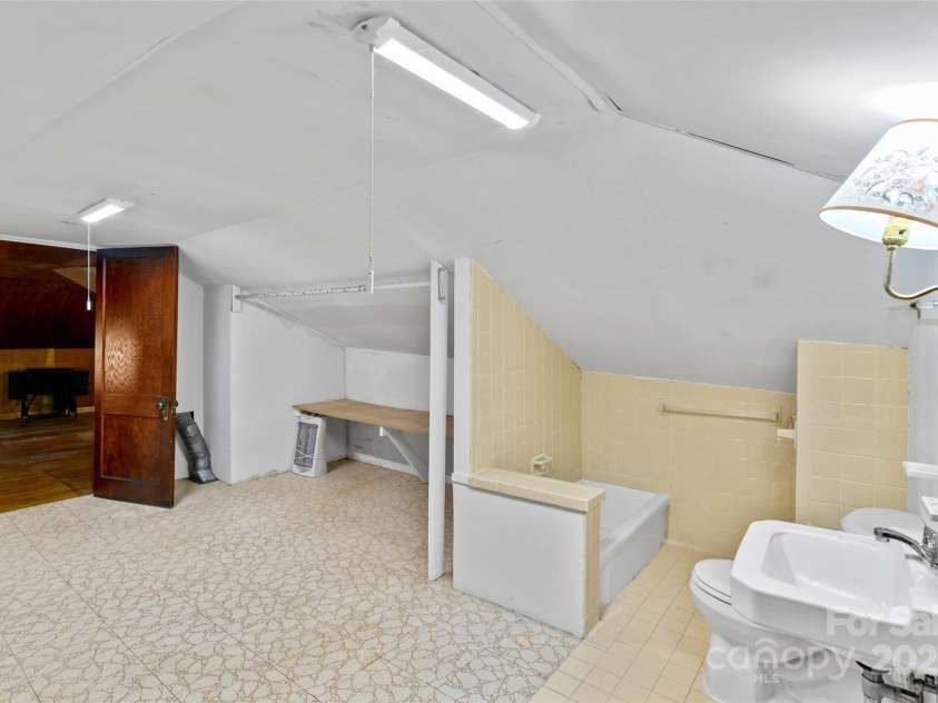 23 & 25 Oteen Park Place, Asheville, NC 28805.  MLS# CAR4287838, YatesRealty ID 29157. This photo shows another view of the bonus attic bathroom with the added extra storage space.