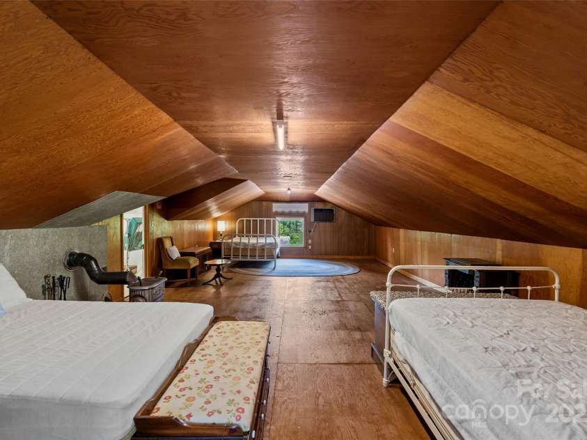 23 & 25 Oteen Park Place, Asheville, NC 28805.  MLS# CAR4287838, YatesRealty ID 29157. With sloped ceilings, the huge attic is a super storage space or could be used as living space as it has a wall AC unit and a wood burning stove.