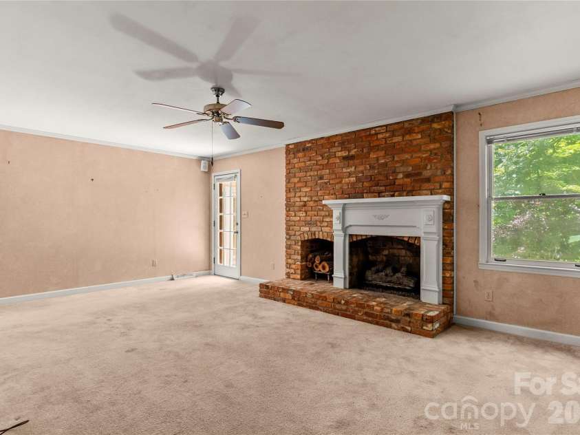 7225 Leesburg Road, Charlotte, NC 28215.  MLS# CAR4389334, YatesRealty ID 29158. Living Room w/ Gas Logs