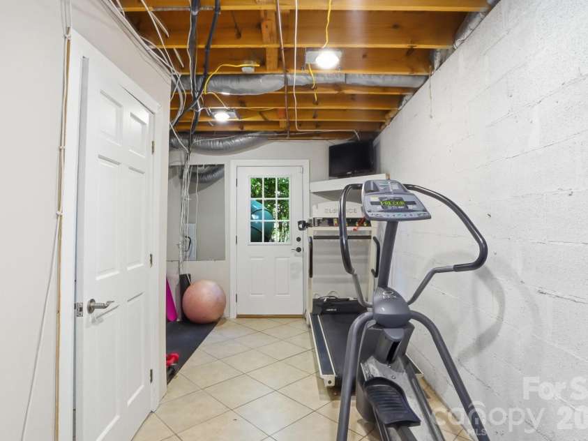 2113 Bon Villa Way, Tega Cay, SC 29708.  MLS# CAR4378887, YatesRealty ID 29174. A adaptable lower level space, ideal as a dedicated exercise room or utilized as much-needed storage.