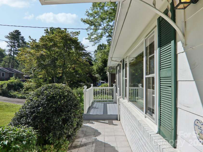 68 Mulberry Court, Arden, NC 28704.  MLS# CAR4283764, YatesRealty ID 29178. Front porch walk toward screened in sunporch