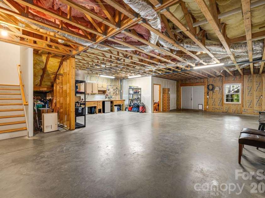 335 Daylily Drive, Hendersonville, NC 28739.  MLS# CAR4387856, YatesRealty ID 29183. Ample workshop and storage space in this basement.