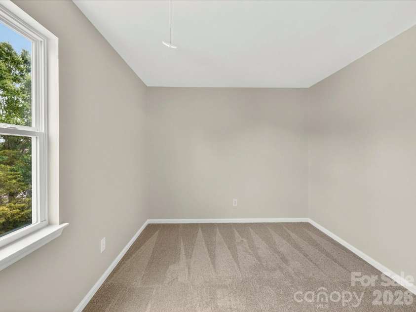 9716 Pernell Lane, Charlotte, NC 28213.  MLS# CAR4383771, YatesRealty ID 29190. Additional secondary bedroom offers soft neutral finishes, plush carpeting, and ample closet space, making it ideal for guests, family, or flexible living needs.