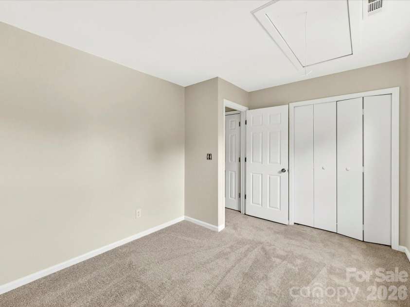 9716 Pernell Lane, Charlotte, NC 28213.  MLS# CAR4383771, YatesRealty ID 29190. Additional secondary bedroom offers soft neutral finishes, plush carpeting, and ample closet space, making it ideal for guests, family, or flexible living needs.