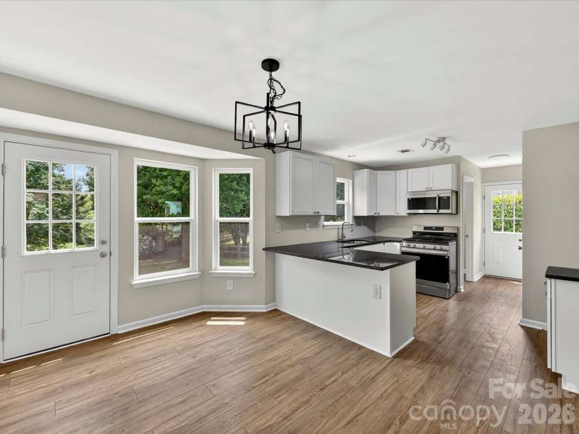 9716 Pernell Lane, Charlotte, NC 28213.  MLS# CAR4383771, YatesRealty ID 29190. Bright and inviting kitchen and breakfast area feature updated finishes, stainless steel appliances, abundant cabinetry, and large windows that fill the space with natural light.