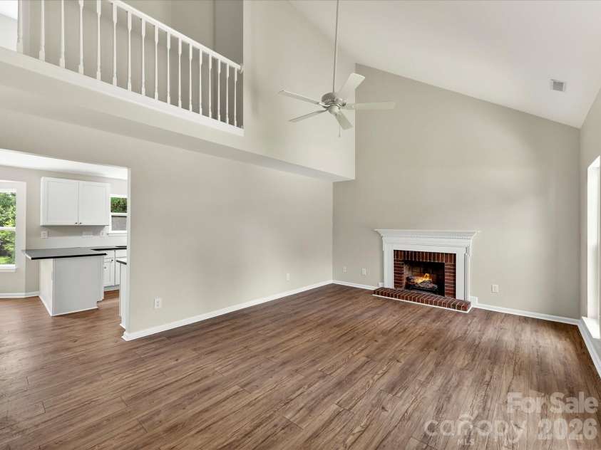 9716 Pernell Lane, Charlotte, NC 28213.  MLS# CAR4383771, YatesRealty ID 29190. Dramatic two-story great room features soaring vaulted ceilings, abundant natural light, updated flooring, and a cozy fireplace creating the perfect open and inviting gathering space.