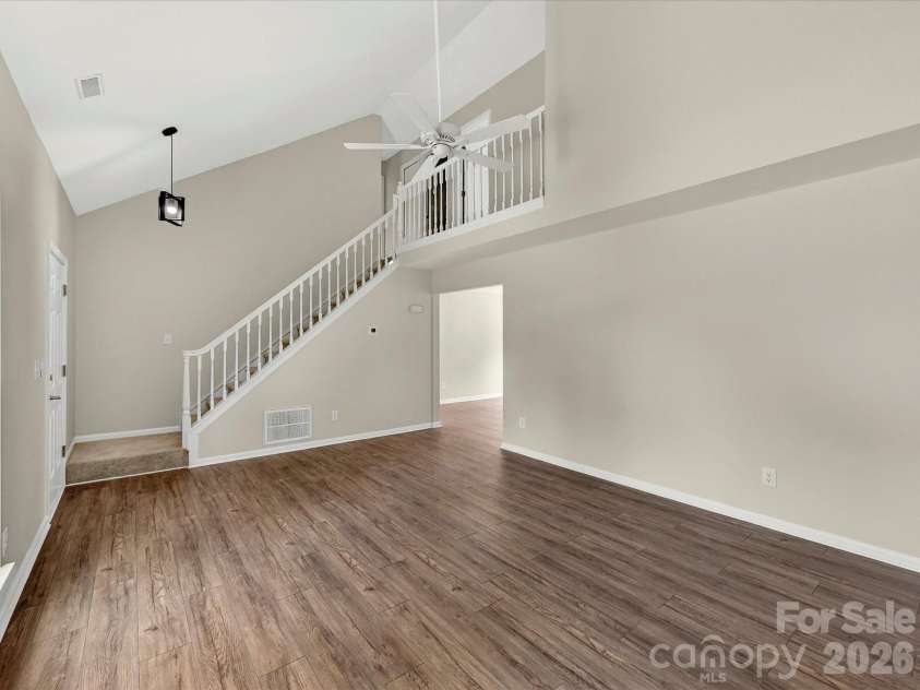 9716 Pernell Lane, Charlotte, NC 28213.  MLS# CAR4383771, YatesRealty ID 29190. Dramatic two-story great room features soaring vaulted ceilings, abundant natural light, updated flooring, and a cozy fireplace creating the perfect open and inviting gathering space.