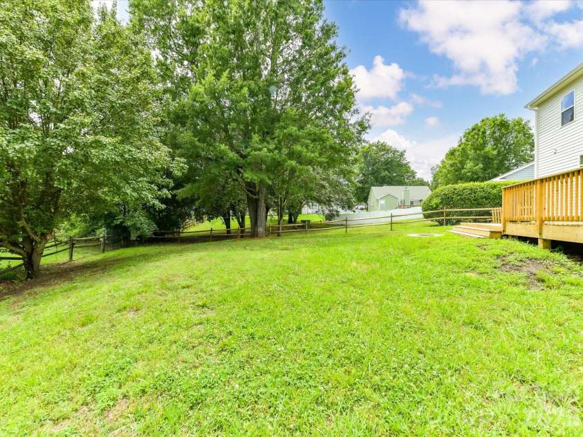 9716 Pernell Lane, Charlotte, NC 28213.  MLS# CAR4383771, YatesRealty ID 29190. Expansive, tree-lined backyard offers plenty of space for outdoor entertaining, play, or relaxing in a peaceful and private setting.