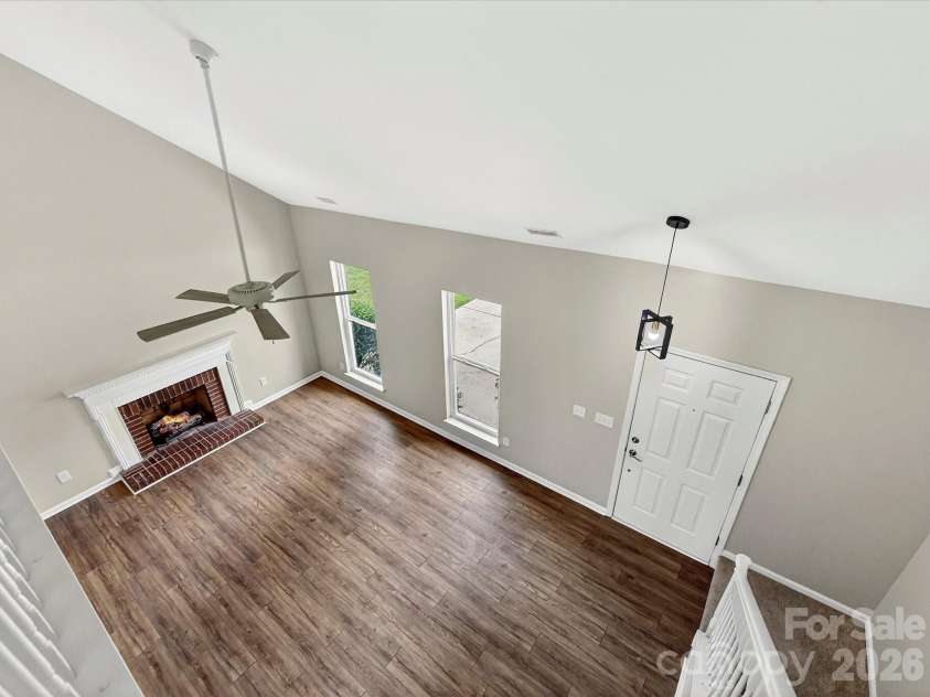 9716 Pernell Lane, Charlotte, NC 28213.  MLS# CAR4383771, YatesRealty ID 29190. Overlook the stunning two-story great room from the open upstairs landing, showcasing soaring ceilings, abundant natural light, and a cozy fireplace centerpiece.