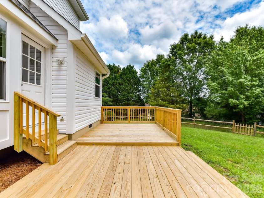 9716 Pernell Lane, Charlotte, NC 28213.  MLS# CAR4383771, YatesRealty ID 29190. Spacious newly built deck overlooking the private backyard offers the perfect space for outdoor entertaining, grilling, or relaxing among peaceful tree-lined views.
