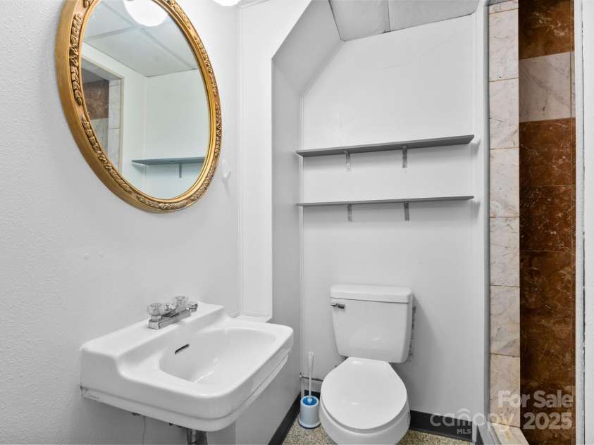 11 Aloha Circle, Candler, NC 28715.  MLS# CAR4313548, YatesRealty ID 292. Half bathroom in the Basement 