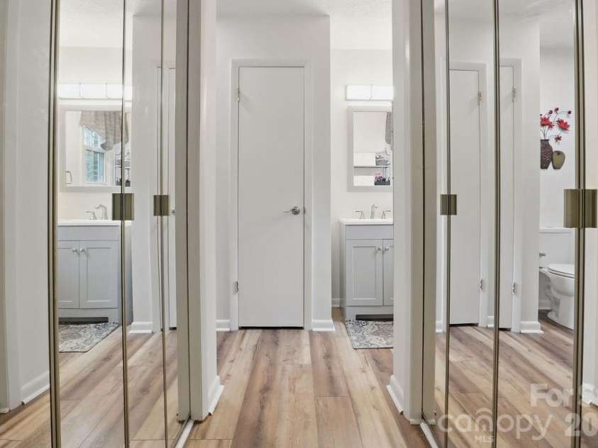114 Falling Waters Road, Hendersonville, NC 28792.  MLS# CAR4390548, YatesRealty ID 29220. Mirrored closet doors leading into primary bathroom