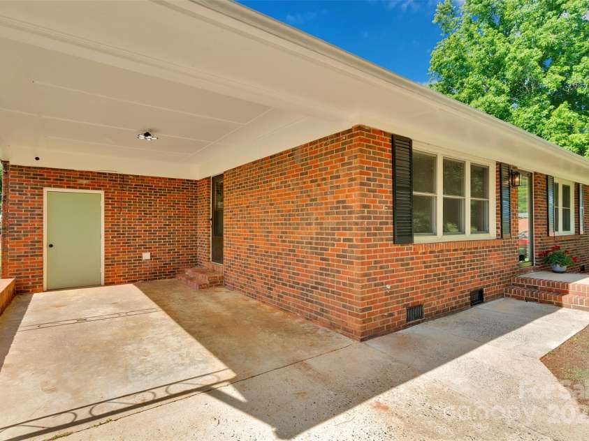 113 Lou Drive, Gastonia, NC 28052.  MLS# CAR4270786, YatesRealty ID 29229. Carport w/ storage room