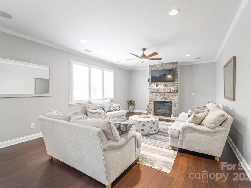 10951 Hat Creek Lane, Davidson, NC 28036.  MLS# CAR4284008, YatesRealty ID 29232. A stacked stone fireplace adds a warm focal point to this cozy den