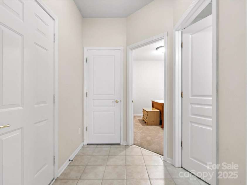 10317 Threatt Woods Drive, Charlotte, NC 28277.  MLS# CAR4283866, YatesRealty ID 29236. Hallway from garage/foyer, to guest room with ensuite bath