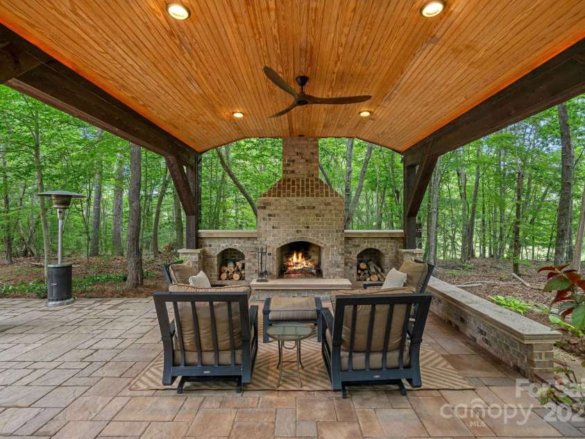 1305 Anniston Place, Wesley Chapel, NC 28079.  MLS# CAR4250299, YatesRealty ID 29238. Covered Outdoor Entertainment Area with stone wood burning FP