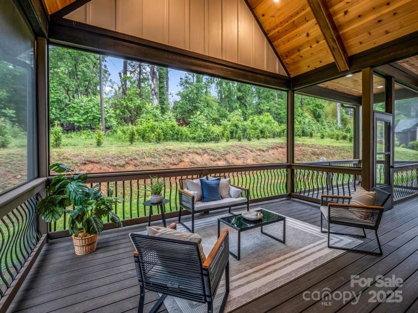 165 Kirkwood Hill Lane, Hendersonville, NC 28739.  MLS# CAR4264440, YatesRealty ID 29239. Covered and enclosed spacious vaulted rear porch