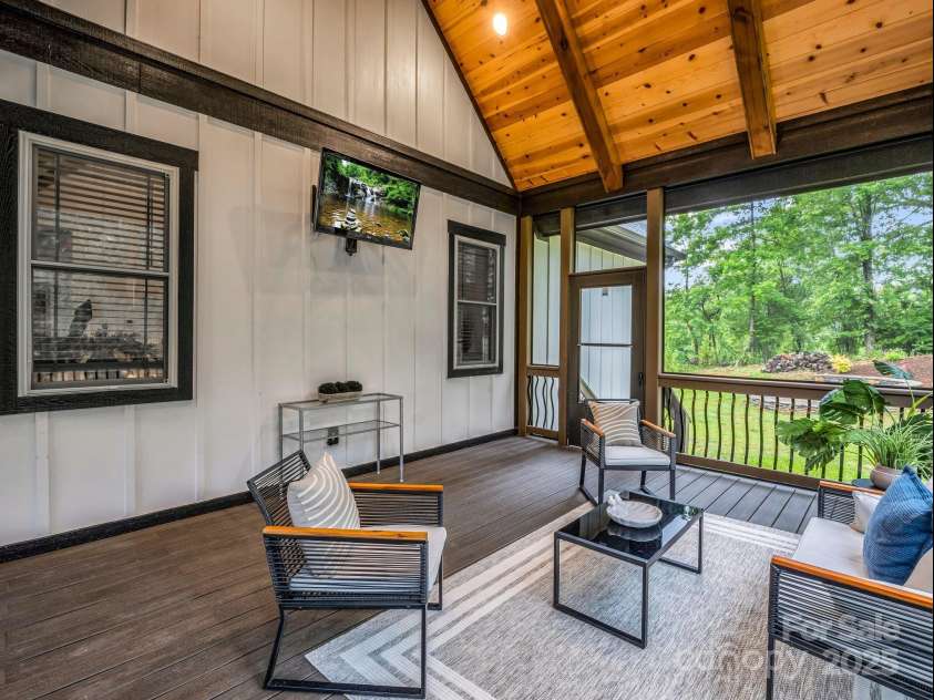 165 Kirkwood Hill Lane, Hendersonville, NC 28739.  MLS# CAR4264440, YatesRealty ID 29239. Covered and enclosed spacious vaulted rear porch