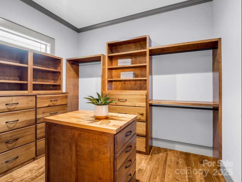 165 Kirkwood Hill Lane, Hendersonville, NC 28739.  MLS# CAR4264440, YatesRealty ID 29239. Spacious Primary Closet with custom built-ins, lumber used from the property